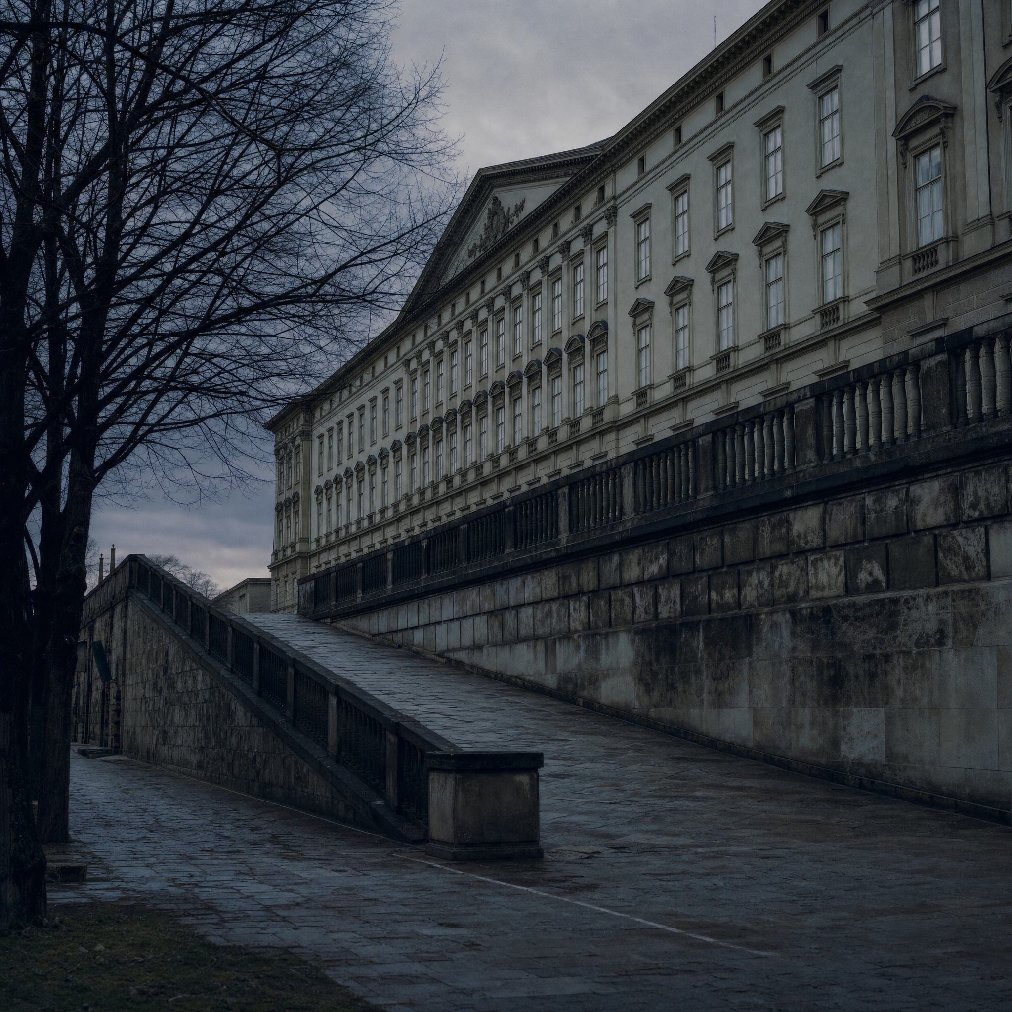 The Albertina's long neoclassical facade standing on the old Augustinian bastion above the street on a bare January evening