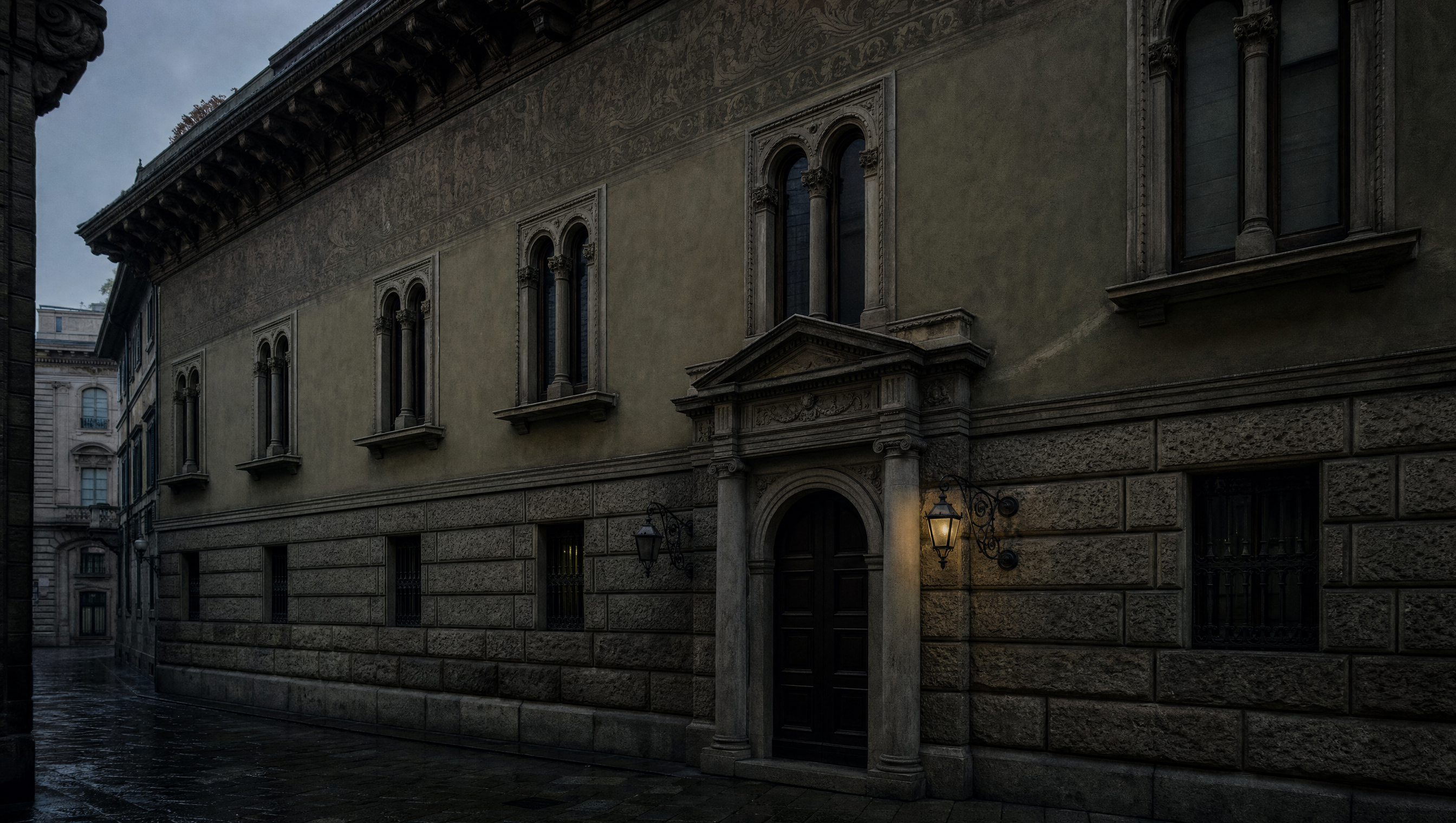 The neo-Renaissance facade on Via Gesù at dusk: rusticated stone below, paired arched windows and sgraffito above