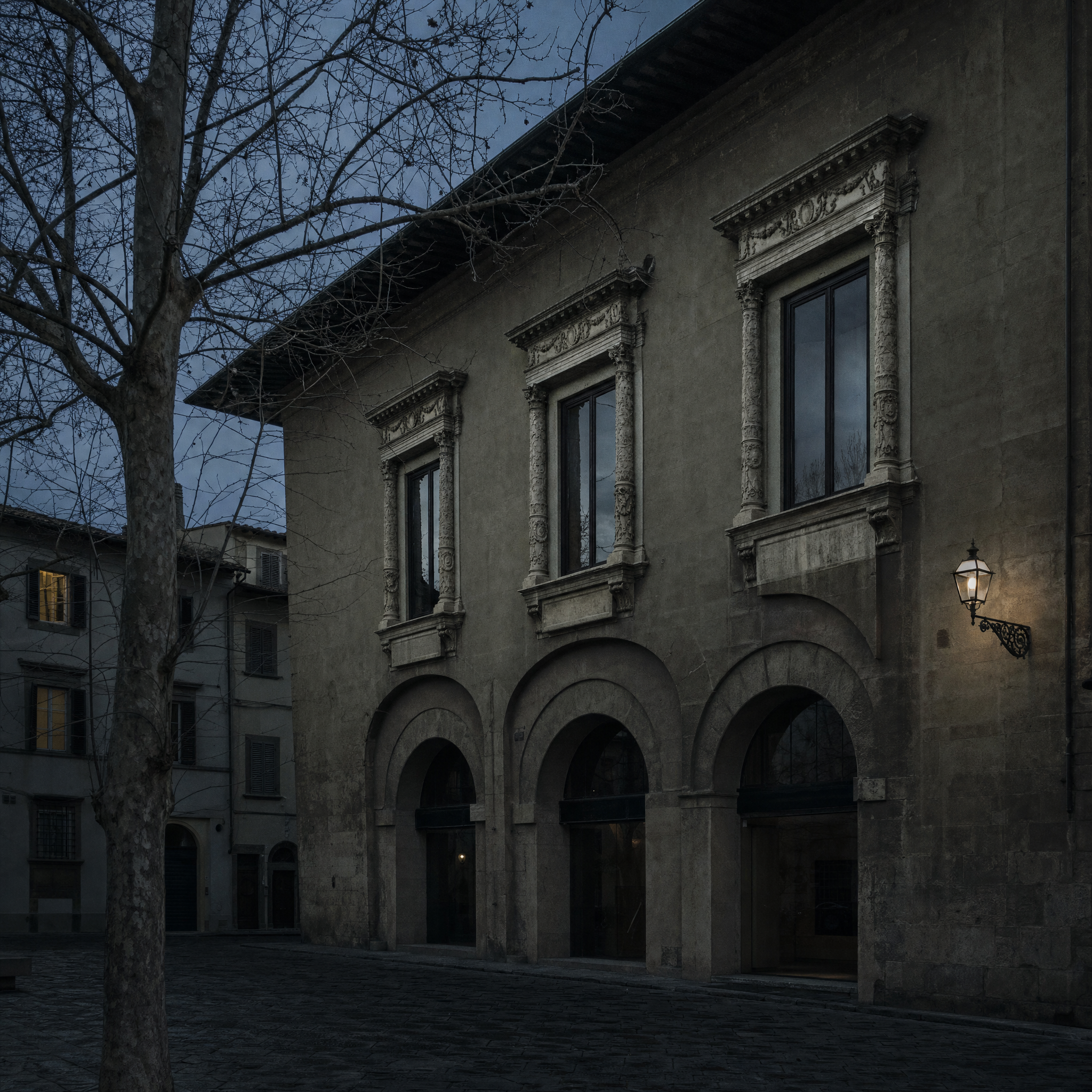The Oltrarno facade of the Museo Stefano Bardini at dusk, its first-floor windows framed by remounted Renaissance altar stone