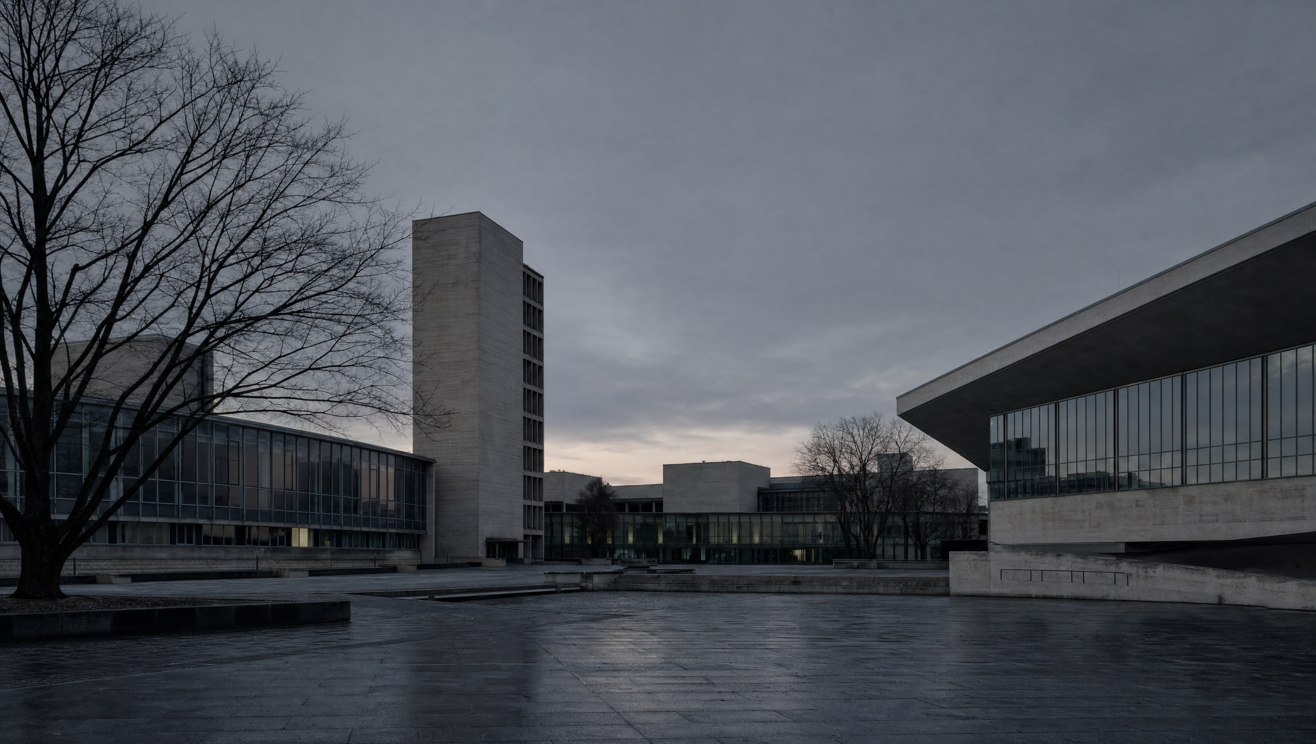 An empty paved plaza in the Kulturforum, bare trees and flat winter light