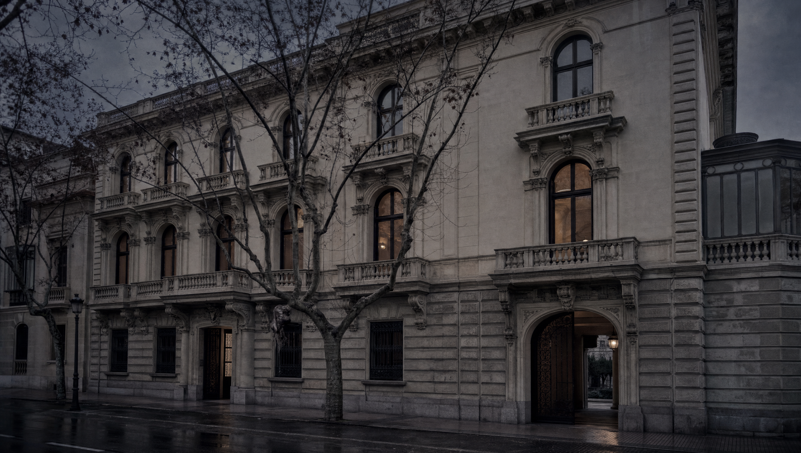 The stone and stucco facade of the Cerralbo palace on Calle de Ventura Rodríguez at winter dusk