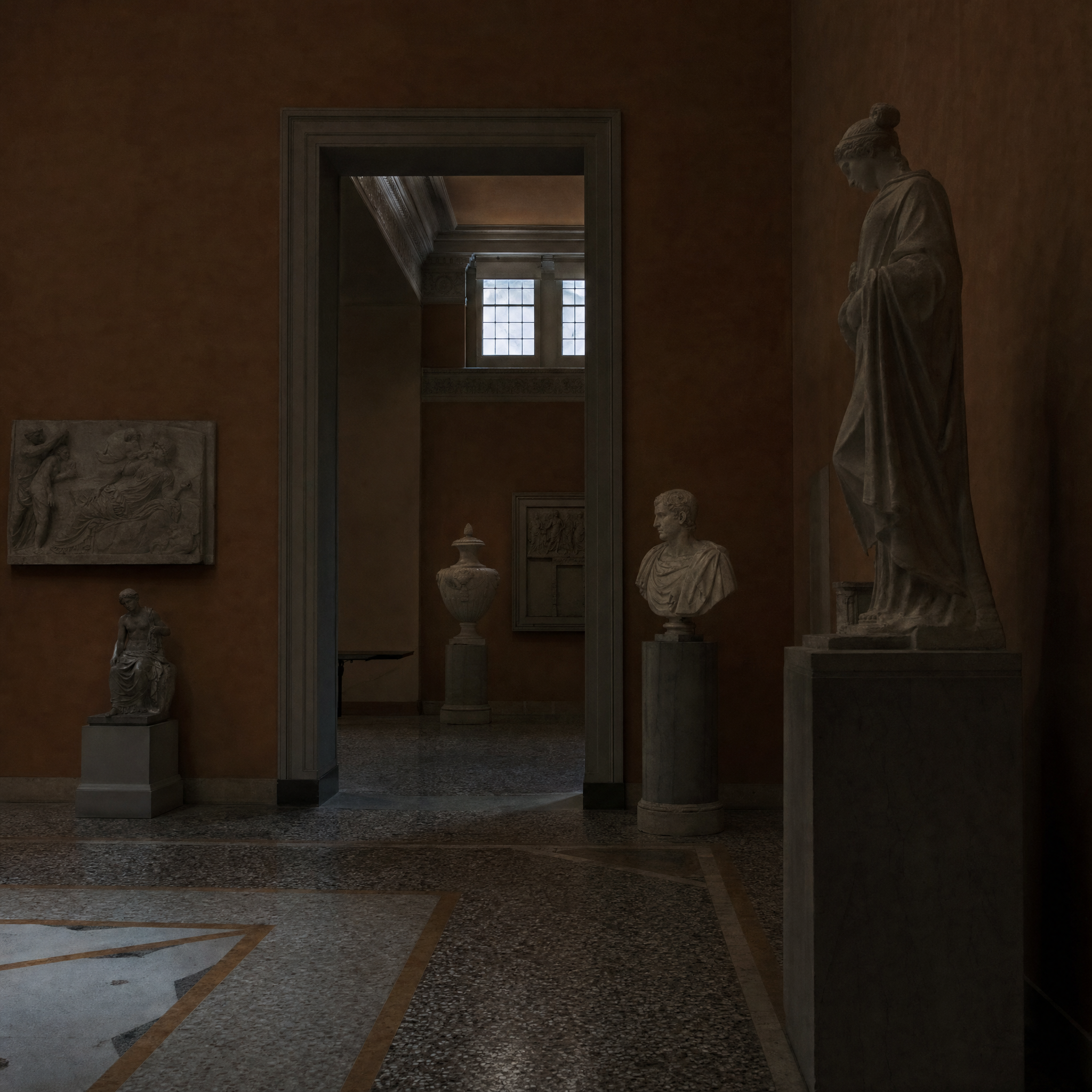 An empty neoclassical gallery with deep ochre walls, plaster statuary and a patterned terrazzo floor