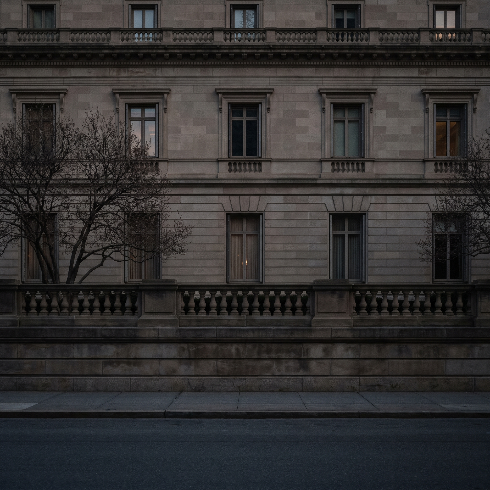 The limestone Fifth Avenue front behind its balustrade at dusk