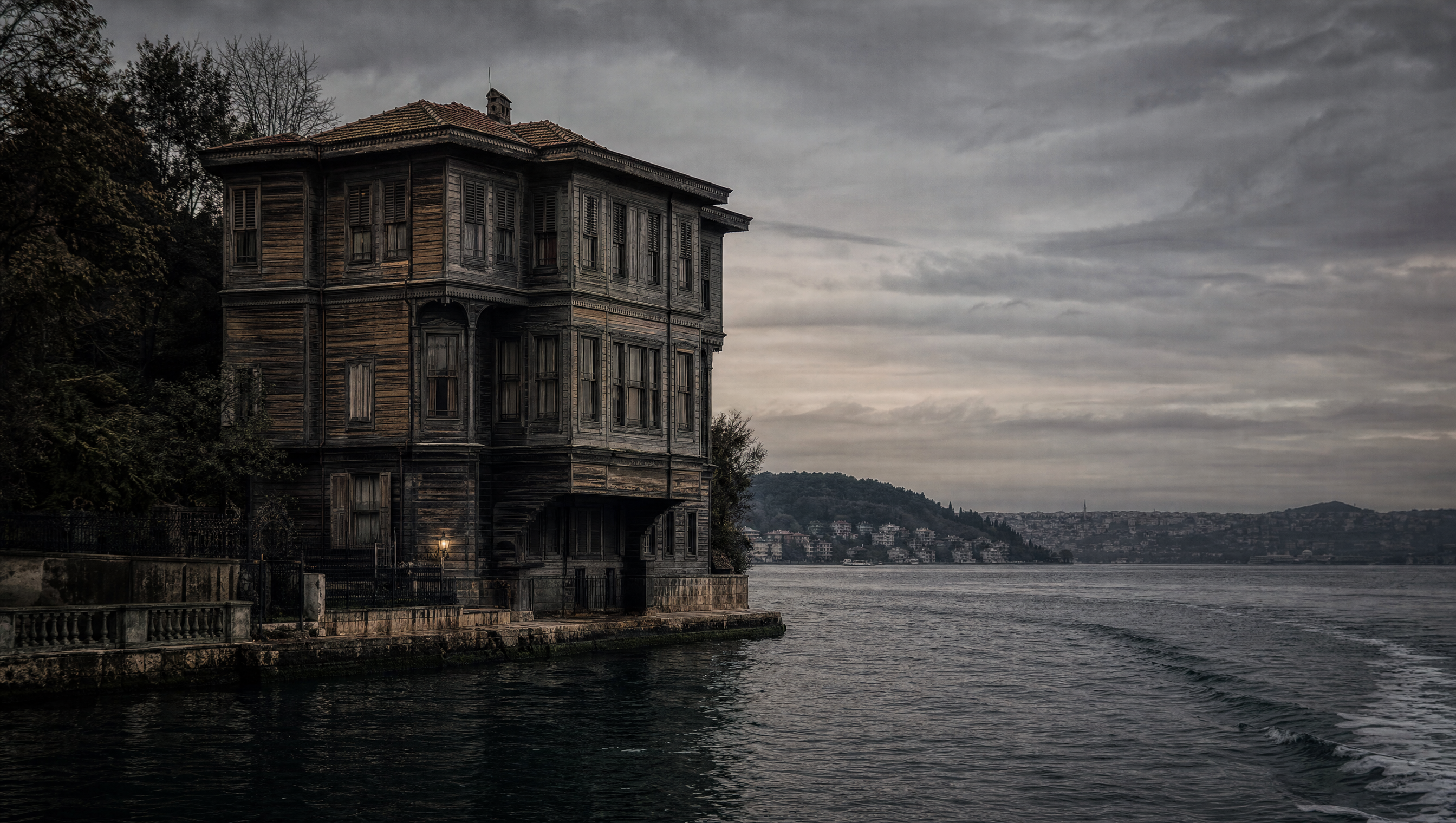 A timber waterfront house on the Bosphorus seen from the water under low overcast light