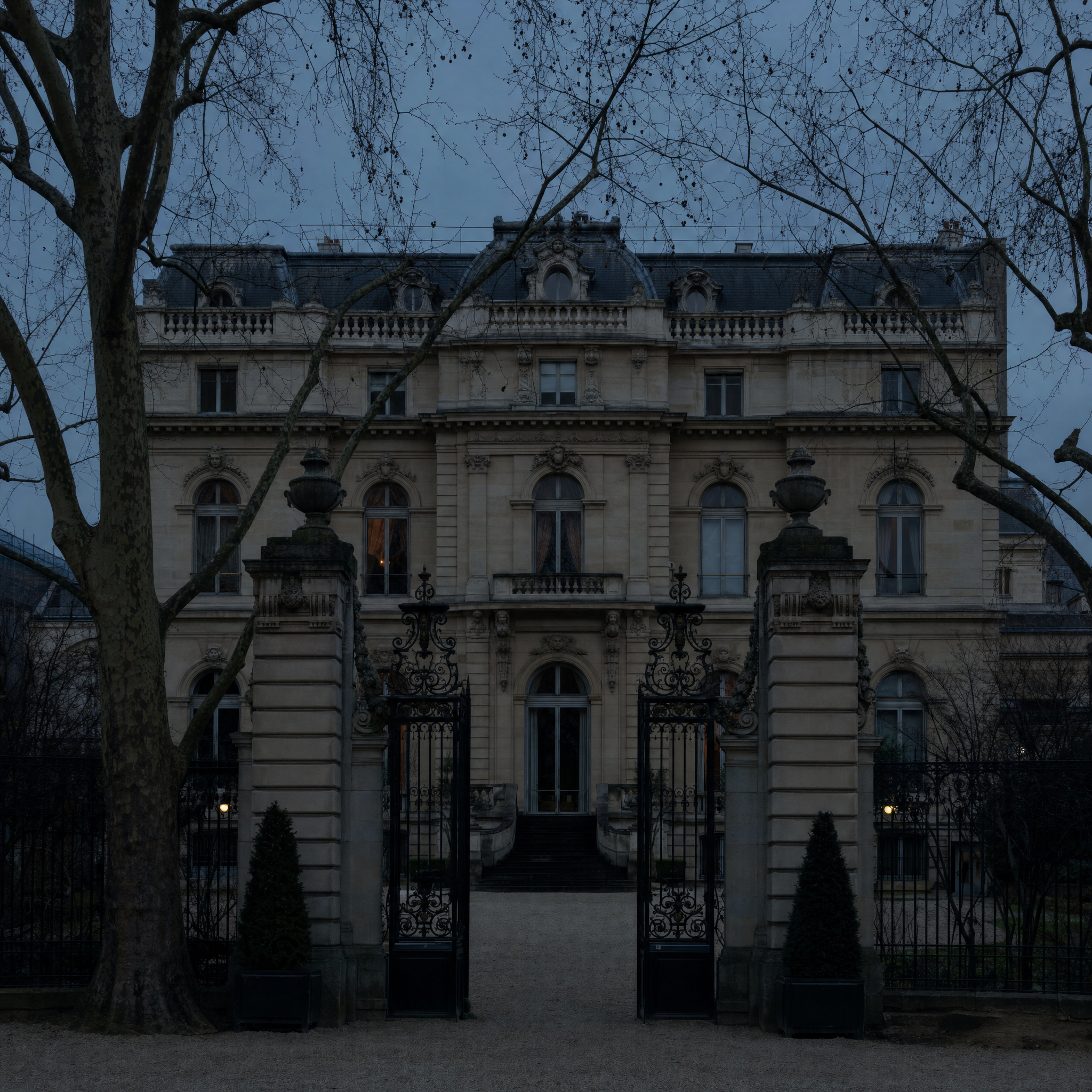 The boulevard Haussmann front of the Musée Jacquemart-André at winter dusk, seen across its gravel forecourt