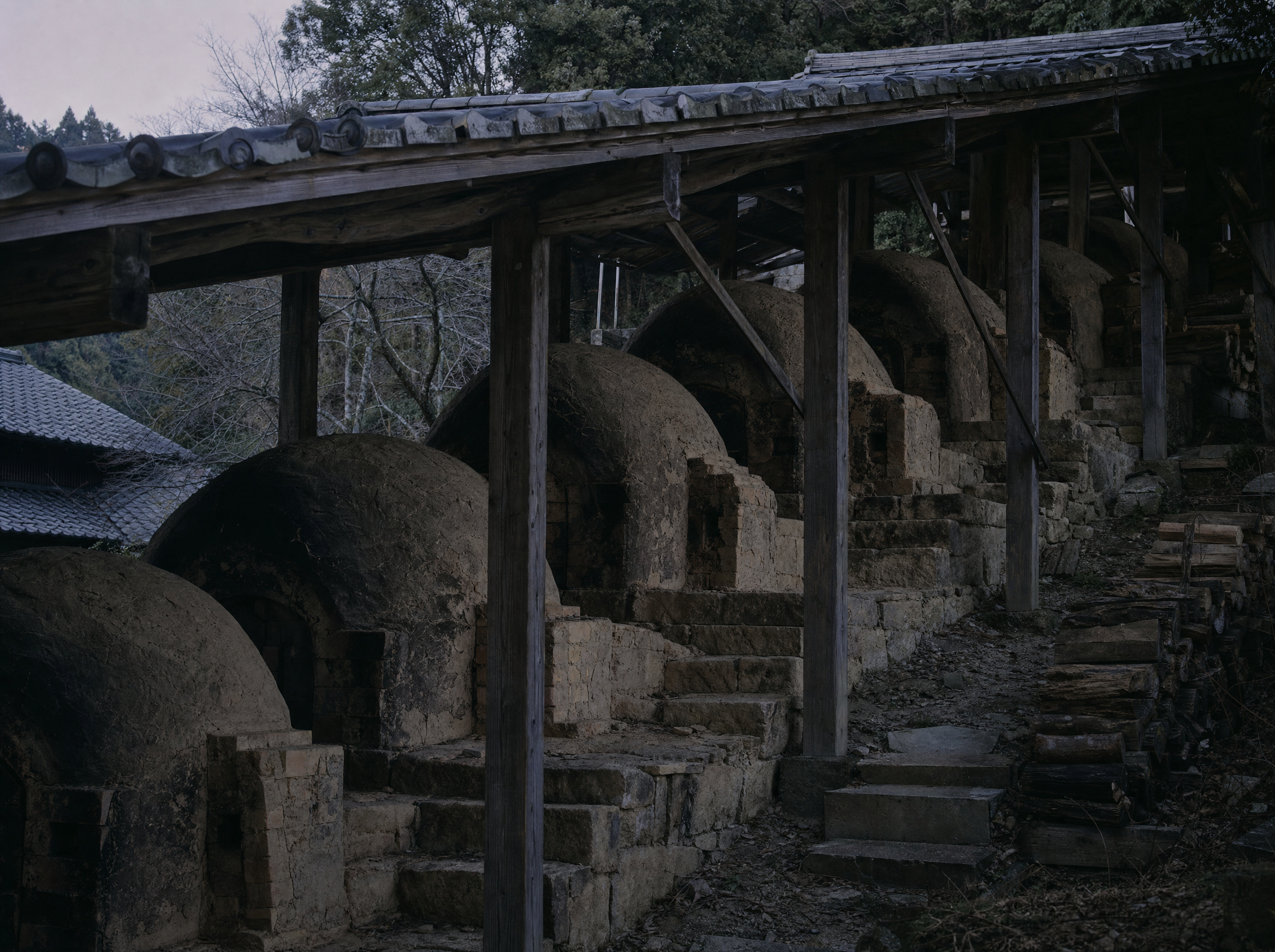 The eight-chambered climbing kiln stepping up the slope behind the house