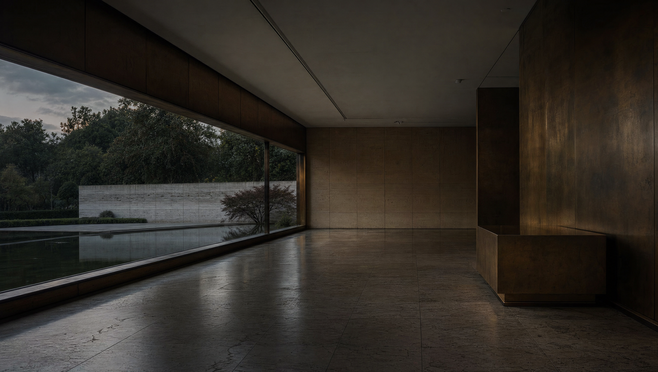 A long low window in an empty modern gallery, opening onto water and mature trees