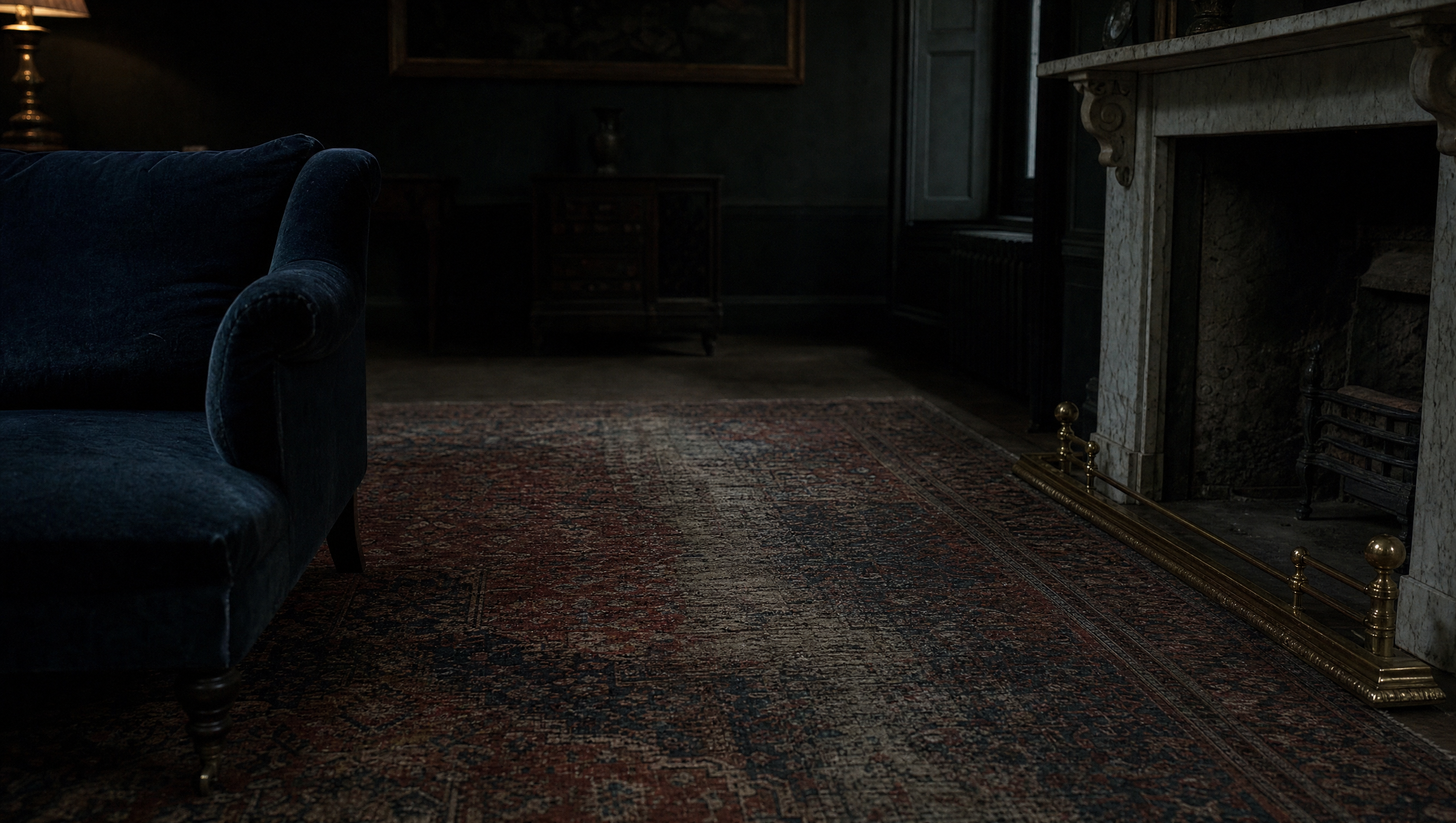The rug at the hearth, worn along its central path