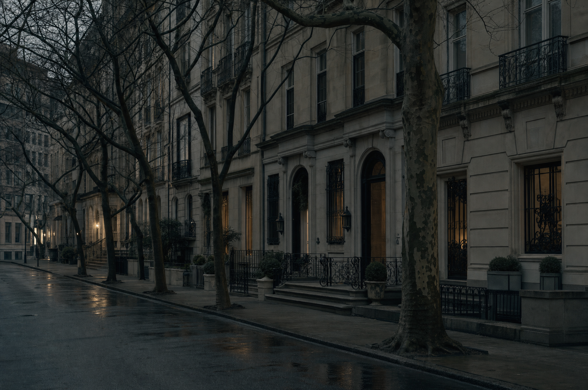Upper East Side townhouse facades at dusk, limestone fronts and bare trees on an empty street