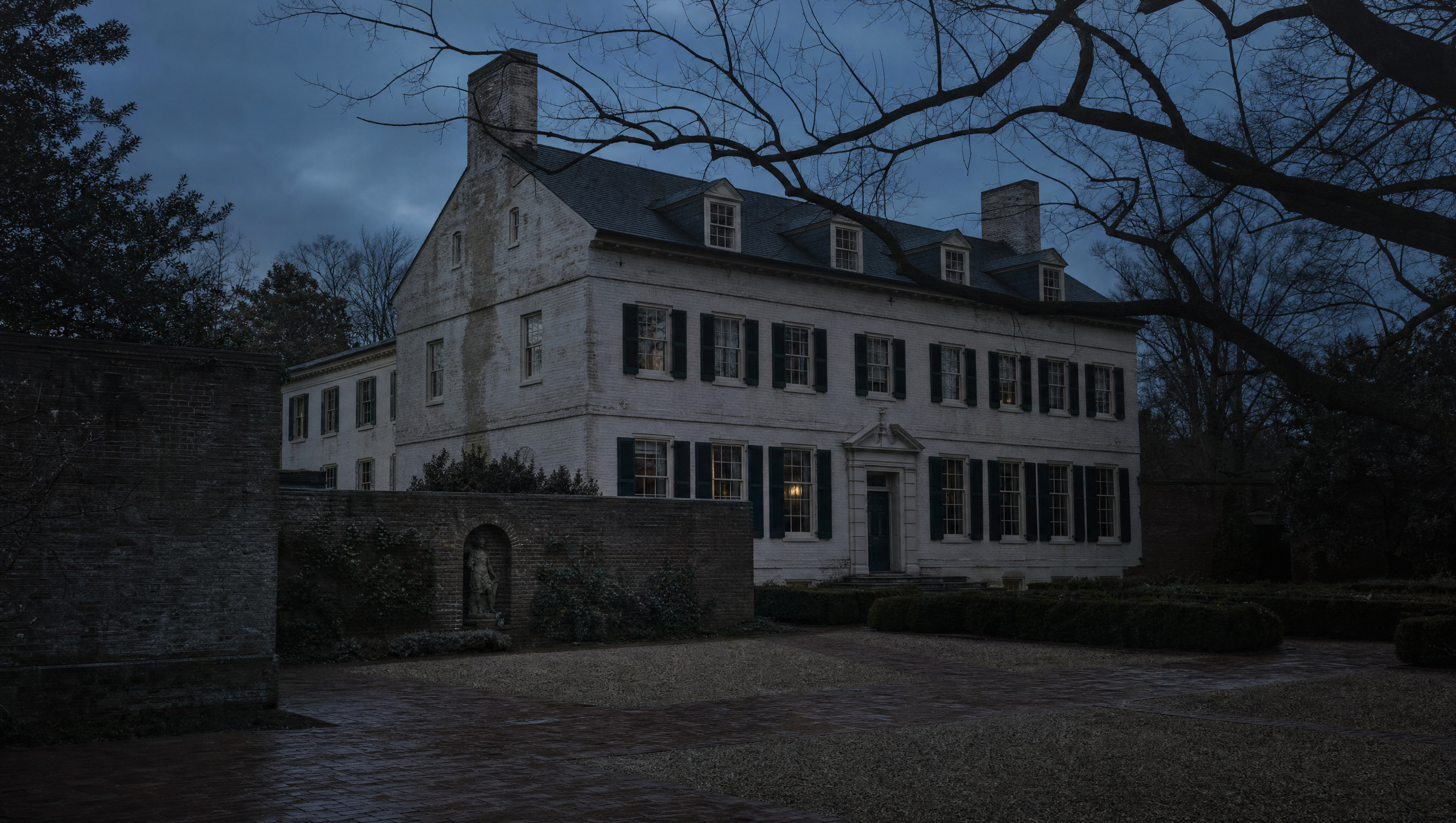 The pale rendered Federal-period front of the Dumbarton Oaks house above its brick garden wall at dusk