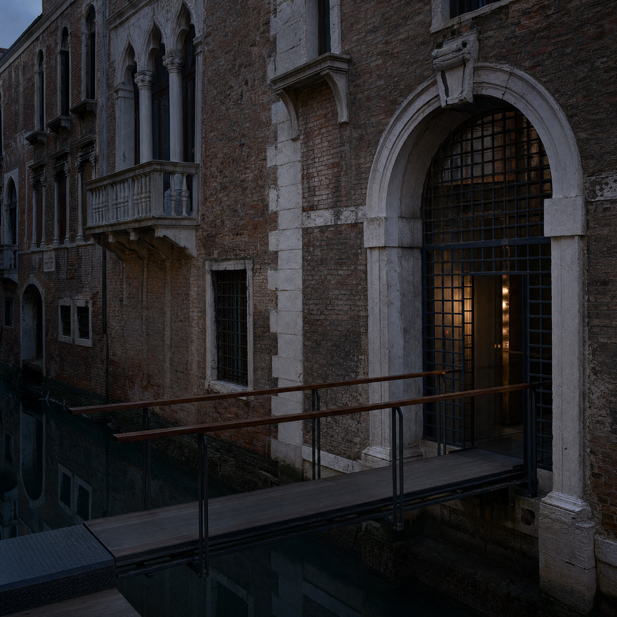 The canal facade of Palazzo Querini Stampalia at blue hour, with Carlo Scarpa's steel and teak footbridge crossing the rio to the water gate