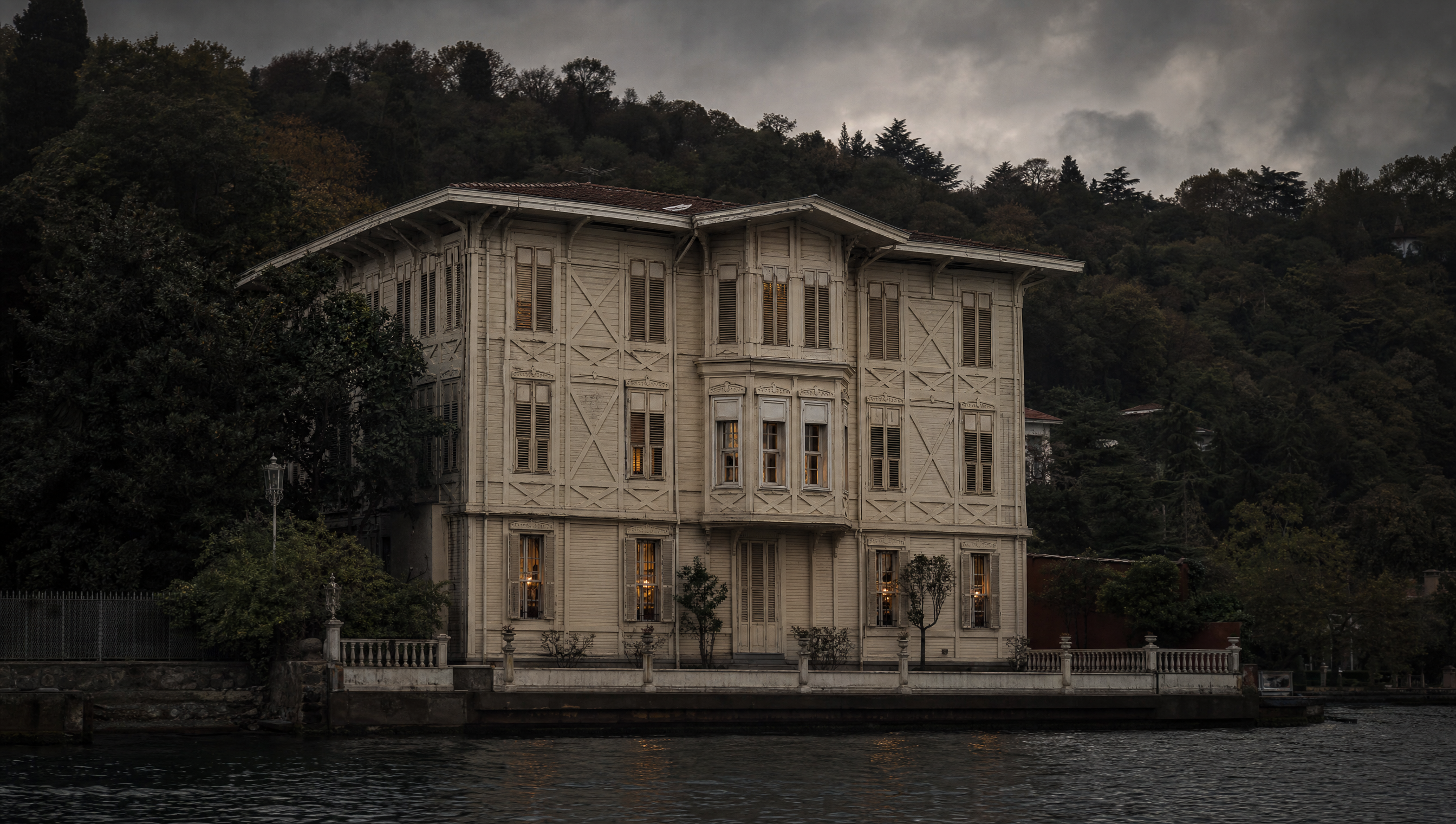 The timber waterfront facade of the Azaryan Yalı on the Bosphorus at Büyükdere, seen from the water at dusk