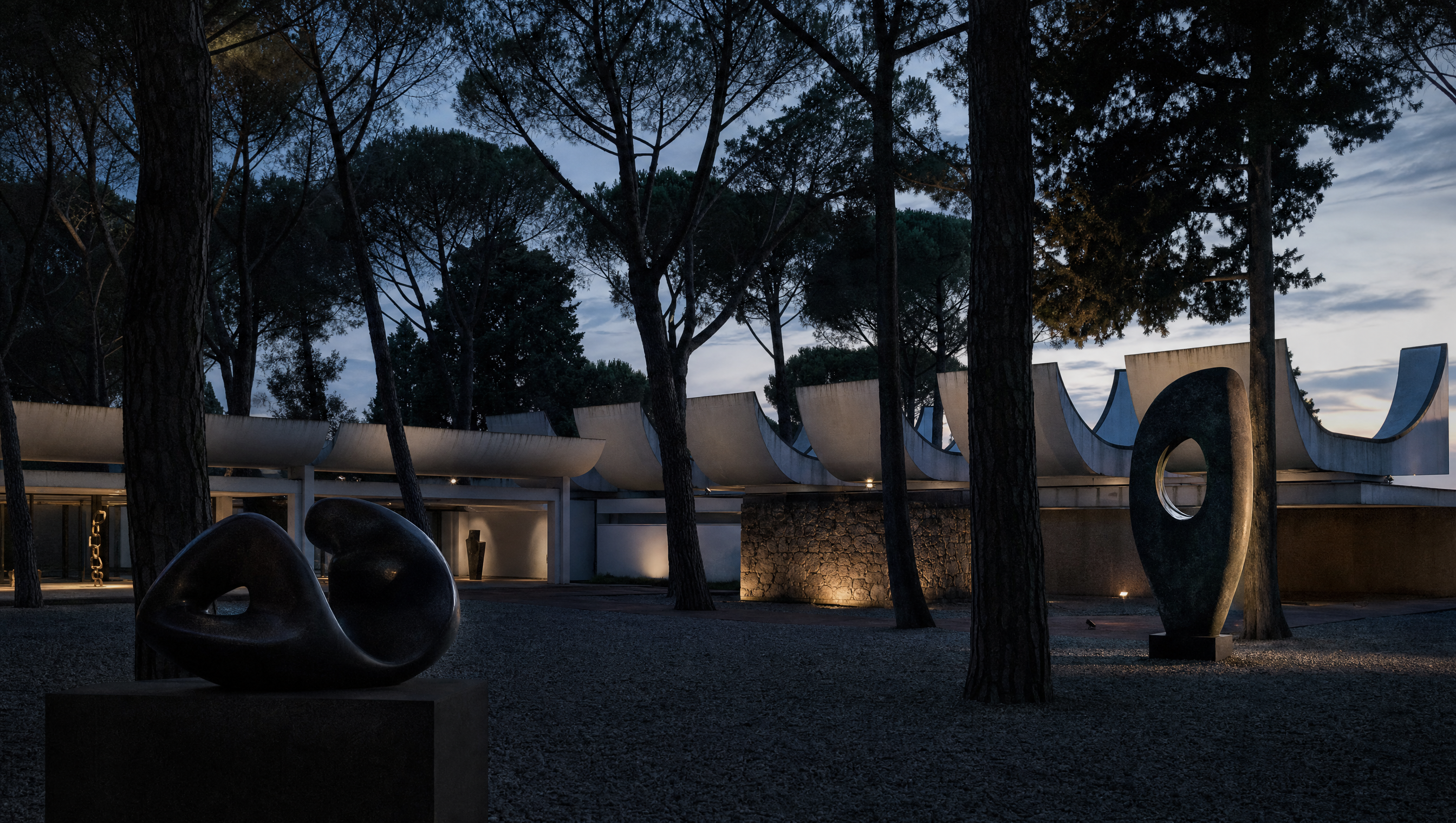 A sculpture courtyard among umbrella pines at dusk, white concrete roof scoops and abstract forms in silhouette