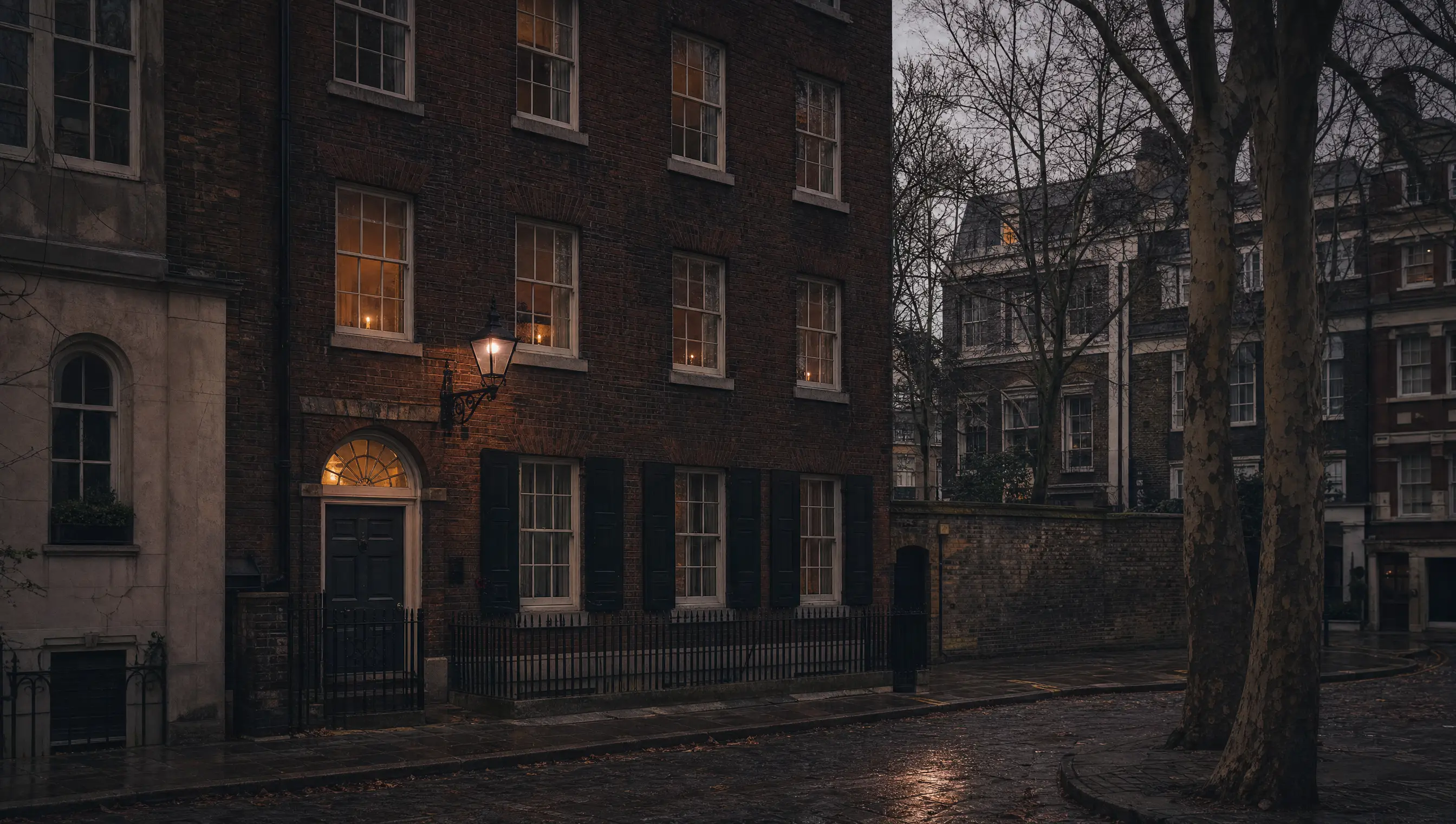 A narrow Georgian brick terrace in Spitalfields at twilight, candlelight behind the upper sashes