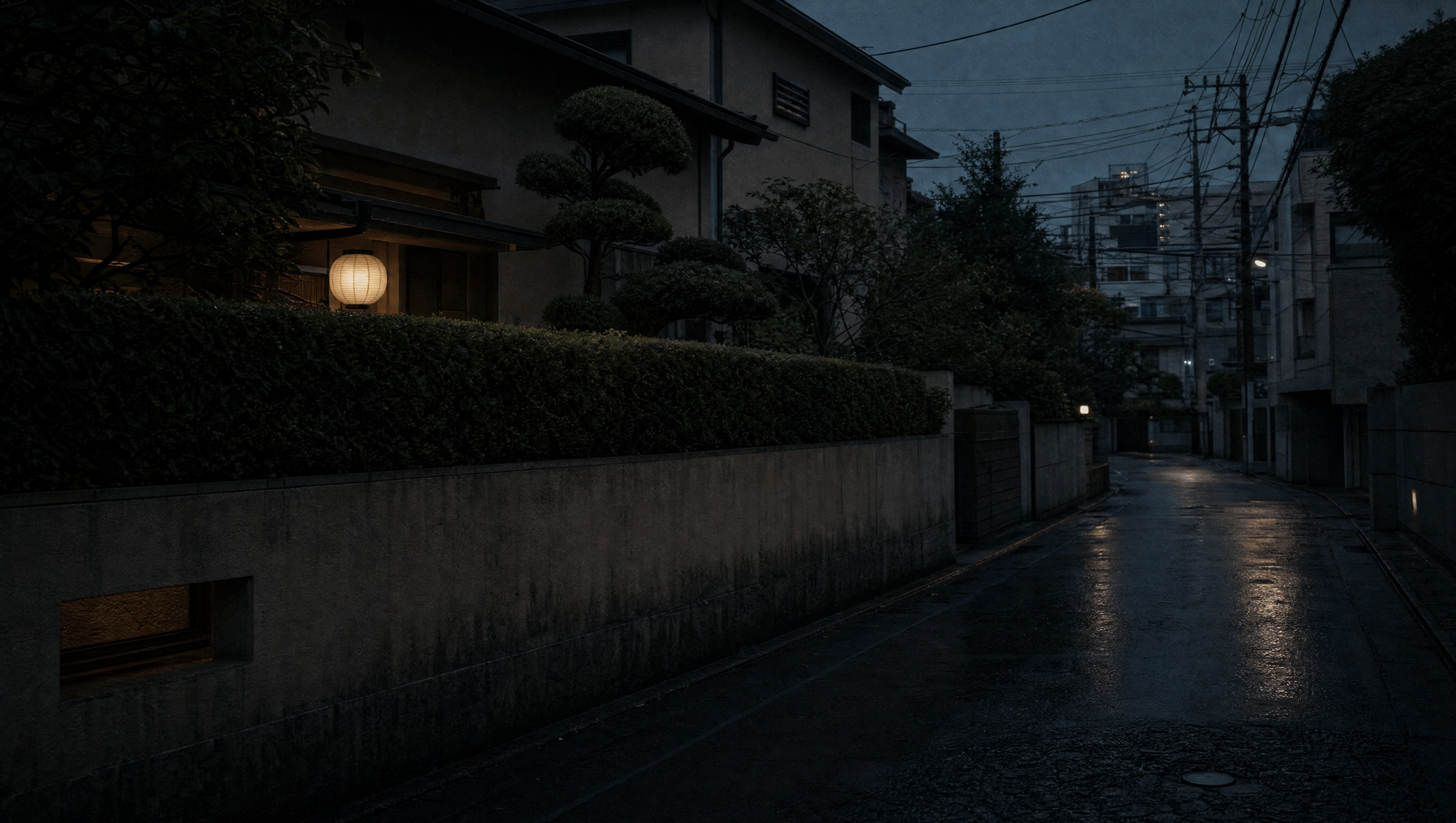 A quiet Tokyo backstreet at blue hour, low garden wall and clipped hedge under telephone wires